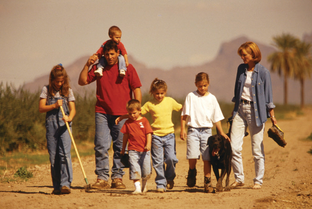 Rea Family walking through olive grove